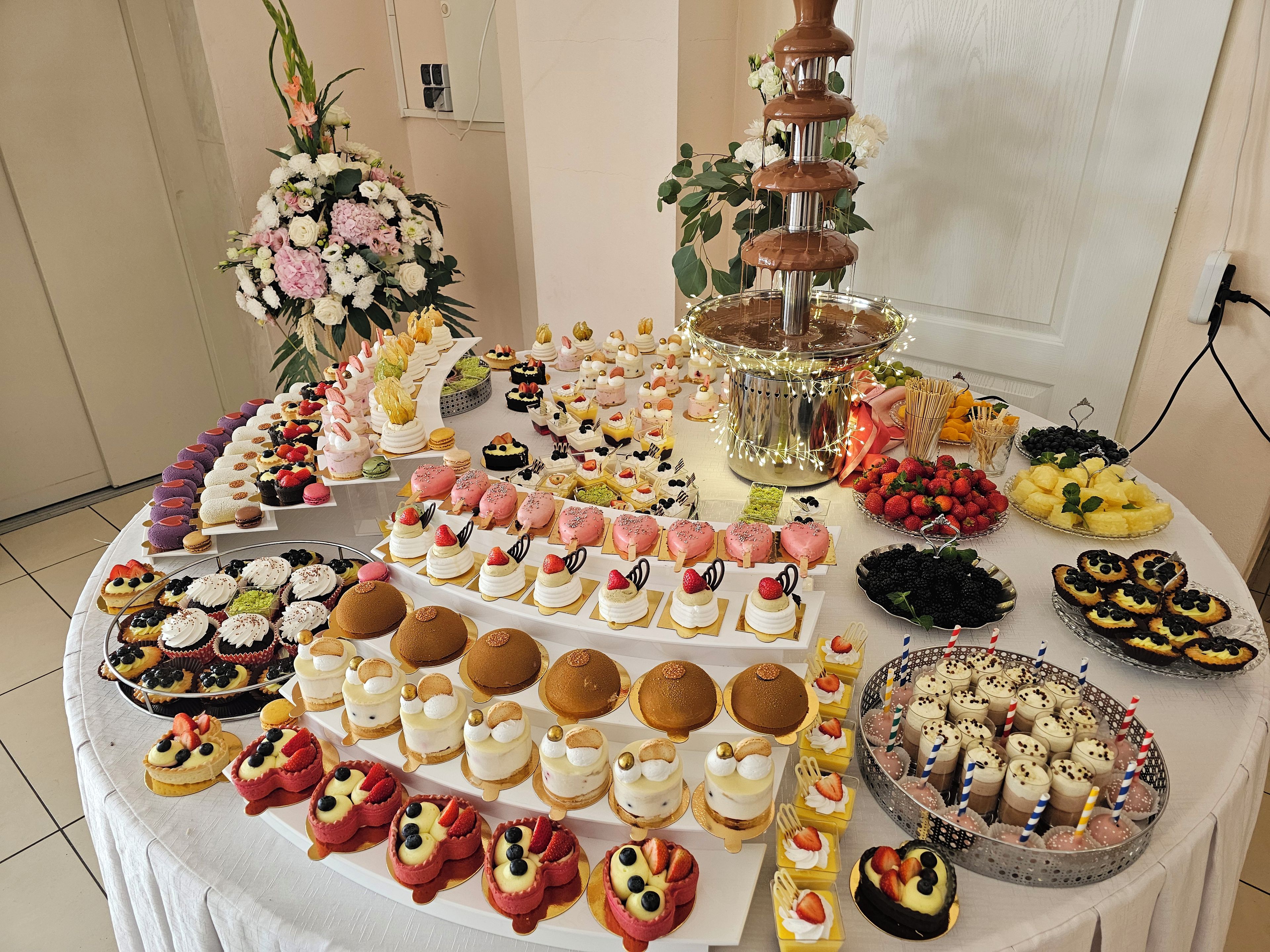 A buffet table with various desserts and a chocolate fountain.
