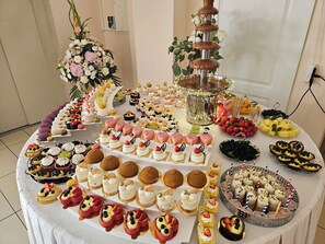 A buffet table with various desserts and a chocolate fountain. - Złota Róża (Sedziszow)