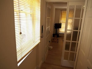 Enter a simple, functional room with a television and a comfortable bed.