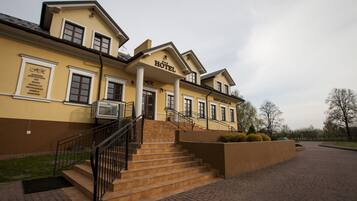 Classic hotel with a central entrance, restaurant, and beautifully landscaped garden.