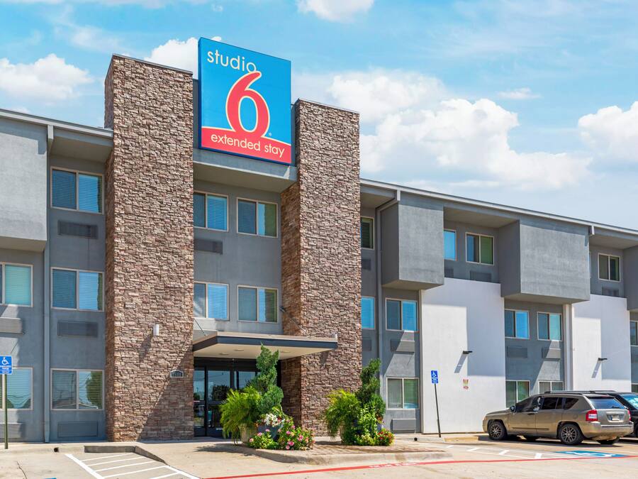 A multi-story hotel with a prominent 'Studio 6 Extended Stay' sign.