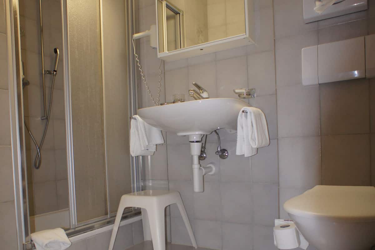 single room | bathroom | shower, hair dryer, towels, soap