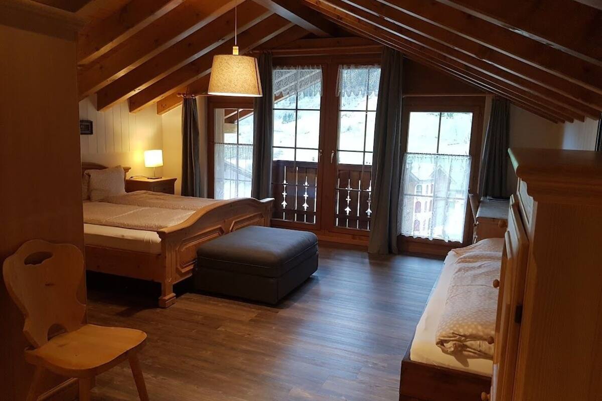 deluxe quadruple room, mountain view | desk, laptop workspace, blackout curtains, soundproofing