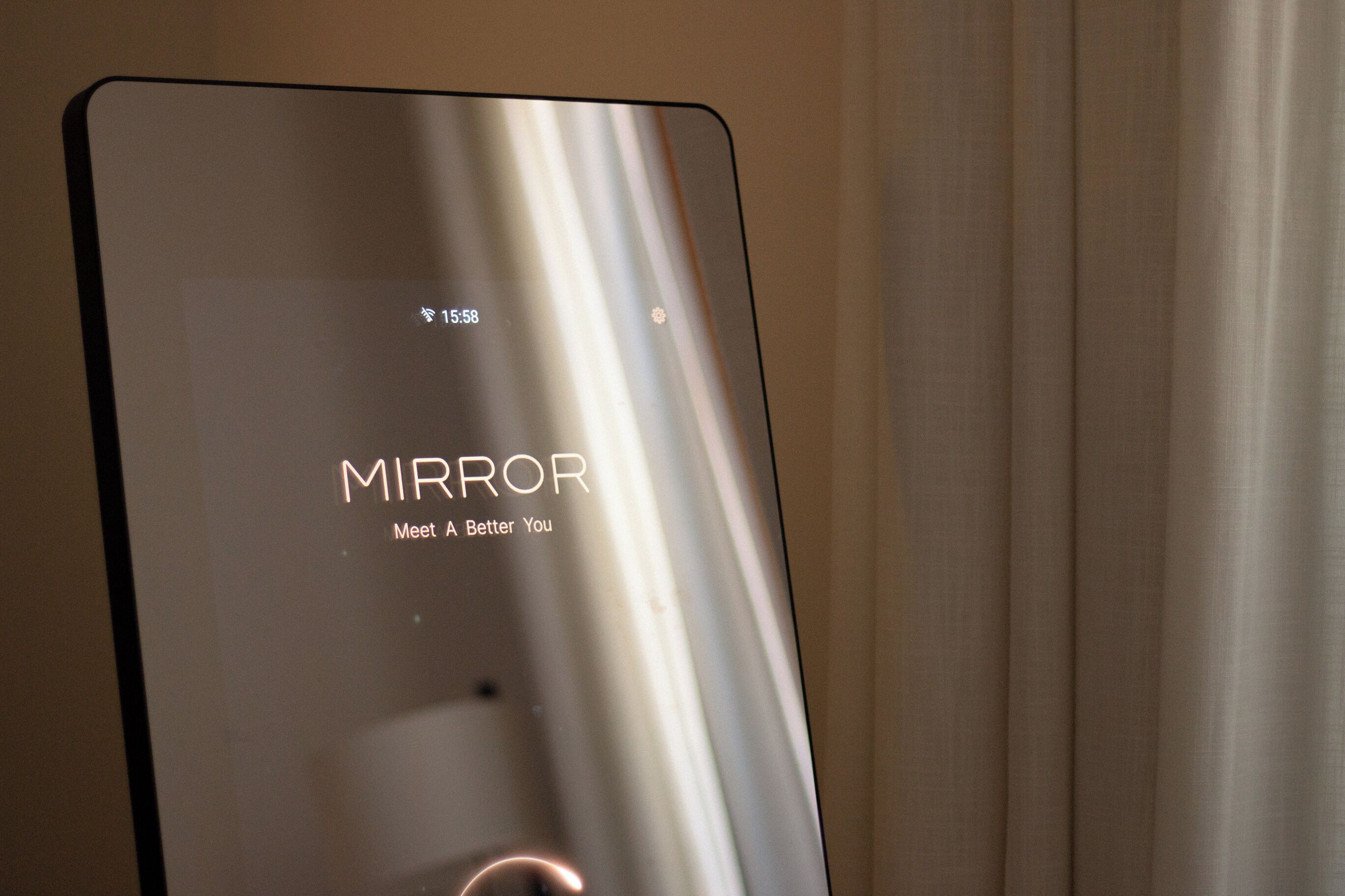 A device with the word "MIRROR" and the phrase "Meet A Better You" on its screen.