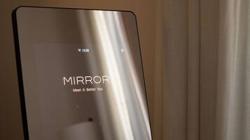 A device with the word "MIRROR" and the phrase "Meet A Better You" on its screen.