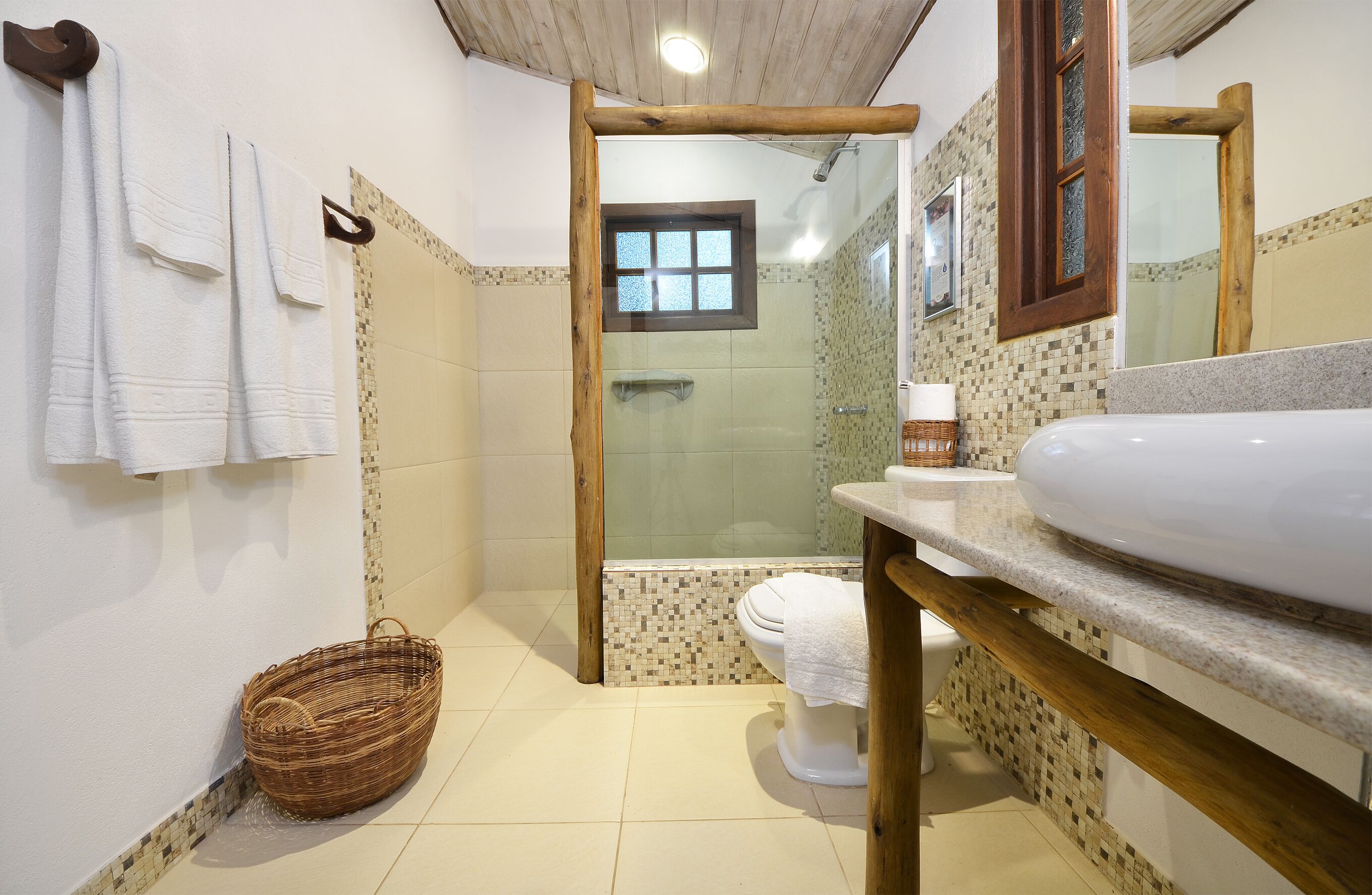 A bathroom with a shower, toilet, and sink.