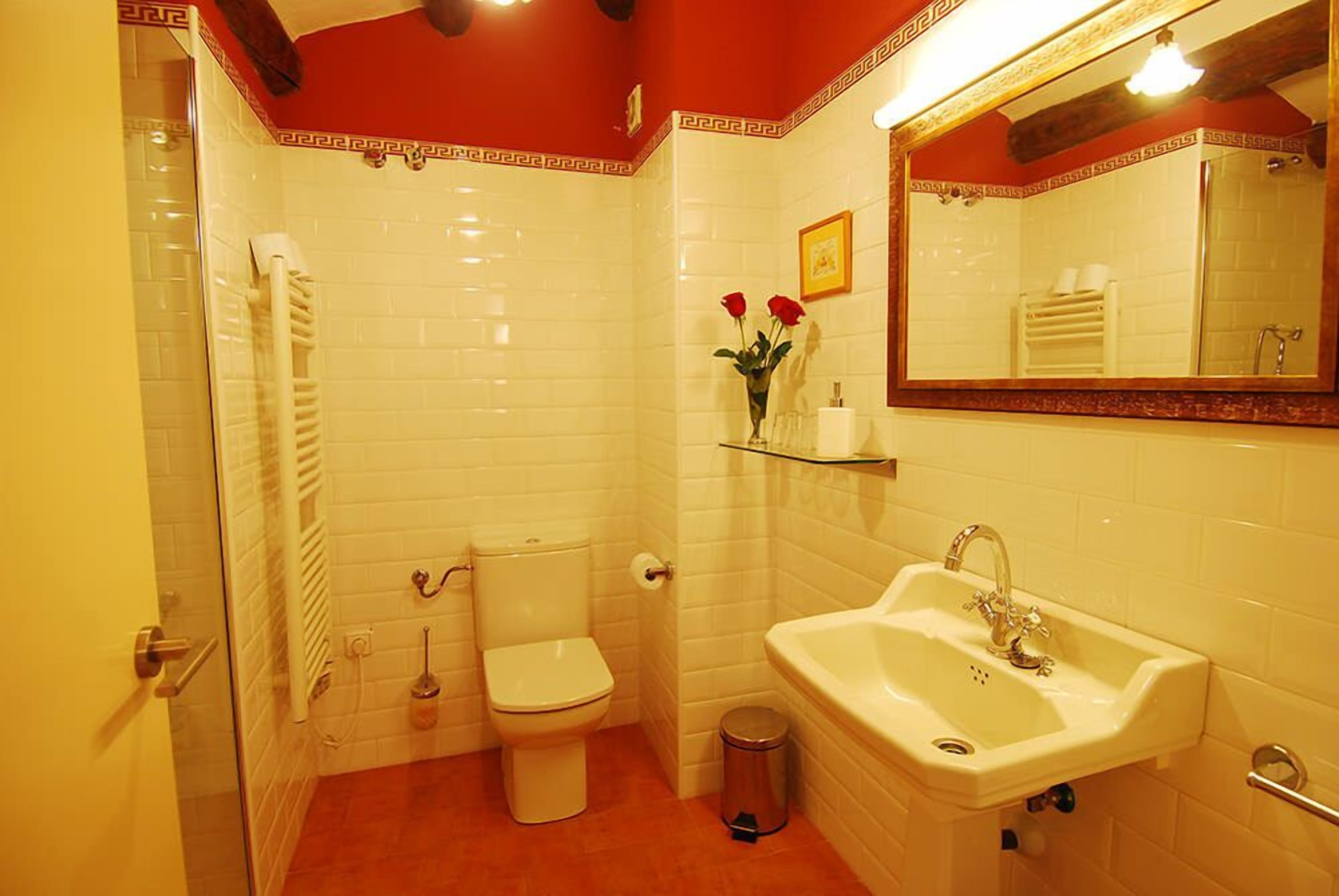 A bathroom with a toilet, sink, and shower.