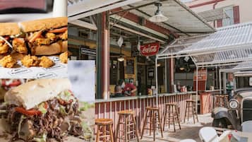 A restaurant with outdoor seating, a vintage car, and a Coca-Cola sign.