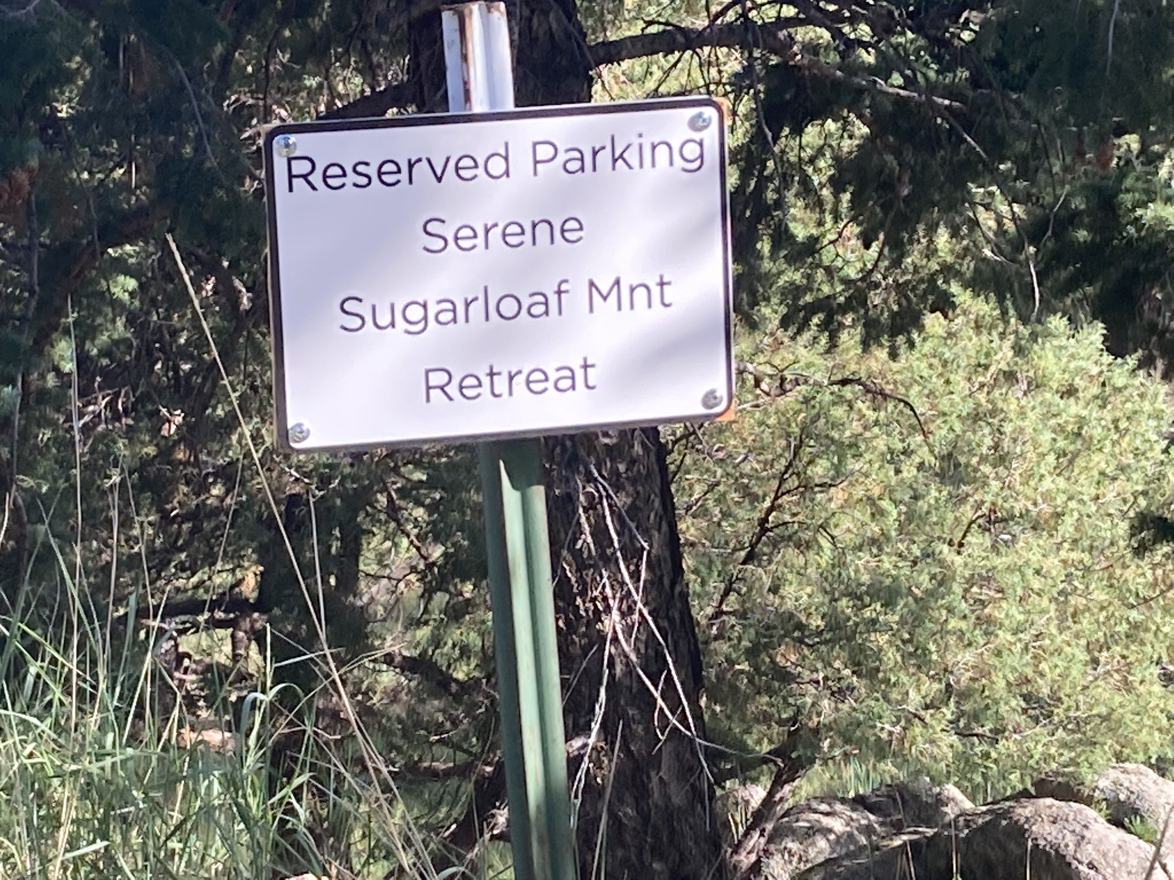 A sign indicating reserved parking at Serene Sugarloaf Mountain Retreat.