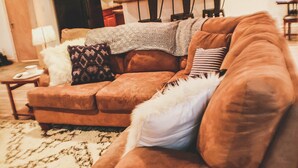 A brown sofa with patterned cushions and a white fluffy pillow. - Mountain Retreat Condo (Kremmling)