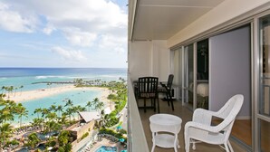 A balcony with a view of a beach and pool area. - Ocean & Lagoon Views.  Don't miss out on our last-minute discounted rate offer! (Honolulu)