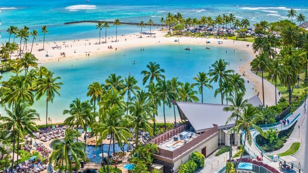 A resort with a beachfront, palm trees, and a pool area. - Ocean & Lagoon Views.  Don't miss out on our last-minute discounted rate offer! (Honolulu)