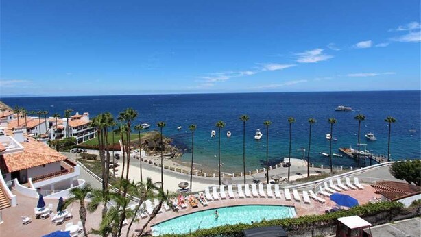 A resort with a pool, beach, and ocean view. - MAGNIFICENT OCEAN VIEW Hamilton Cove Condo With Golf Cart Included. (Avalon)