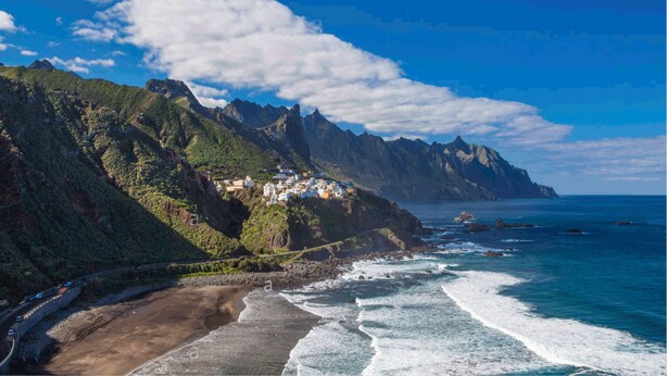 A coastal landscape with a road curving along the beach, cliffs, and a small settlement with buildings on the hillside. - BEST AREA, CITY CENTER, PLAZA DEL CHARCO, IDEAL FOR FAMILIES (Puerto de la Cruz)
