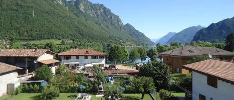 A residential area with houses, a swimming pool, and a view of mountains.