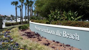 Maisemoitu alue, jossa on kyltti, jossa lukee: «Tervetuloa Jacksonville Beachille».