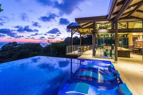 Infinity pool at sunset with ocean views at our luxury villa in Manuel Antonio