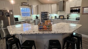A modern kitchen with a large island, stainless steel appliances, and pendant lighting. - 15% Fall Special! Lake Luxury: 6BR/6BA w/ Private Dock| Quiet Cove| (LaFollette)