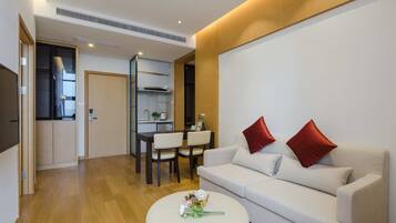 Deluxe Suite, 2 Bedrooms | Living area | TV