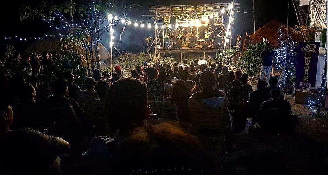 An outdoor event with a stage and audience.
