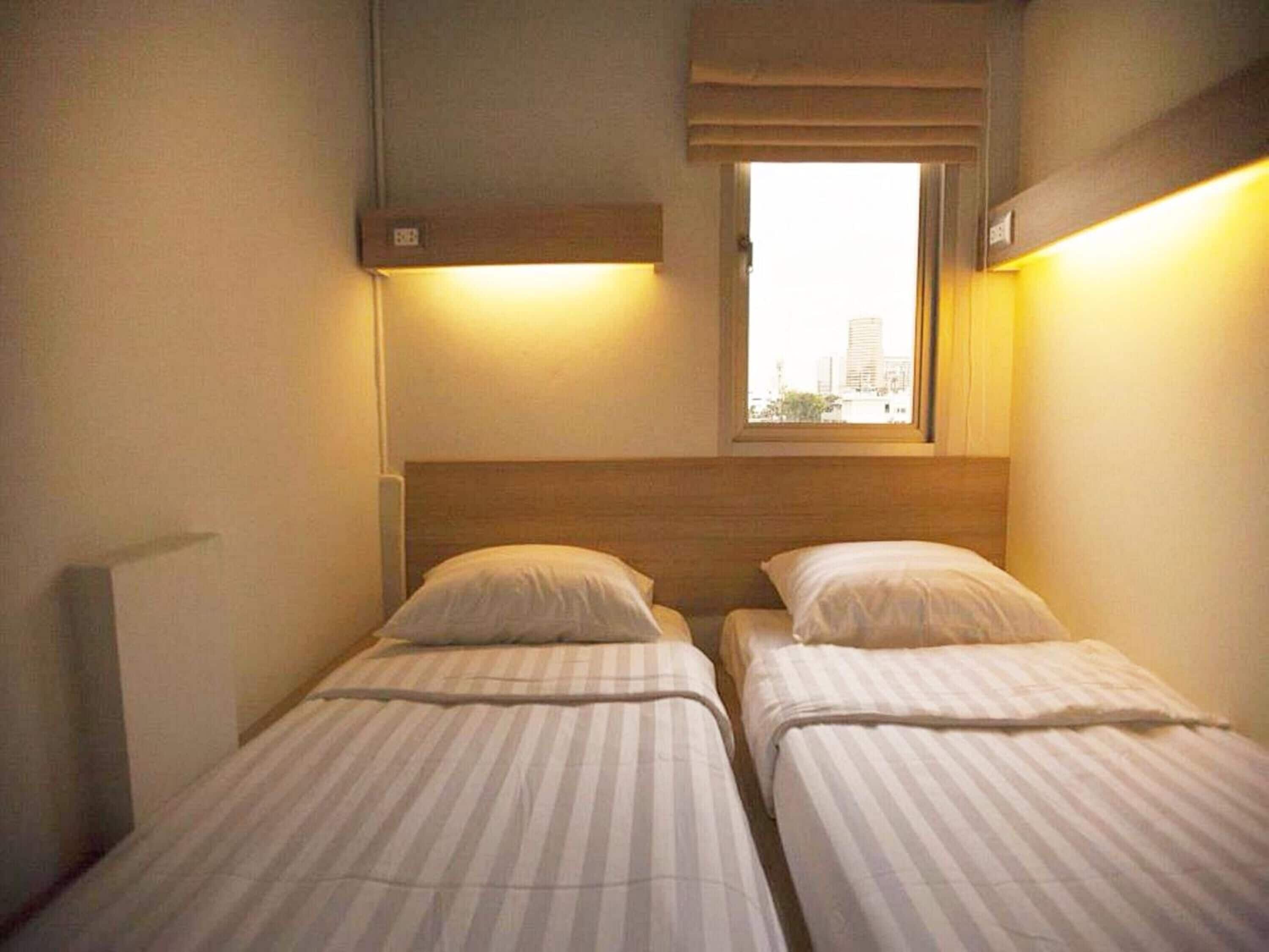 twin bed with shared bathroom | blackout curtains, iron/ironing board, free wifi, bed sheets