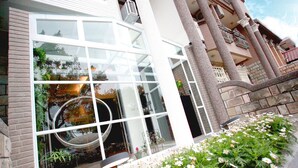 A modern building with large windows, a circular skylight, and a brick facade. - ManMan (Hualien City)