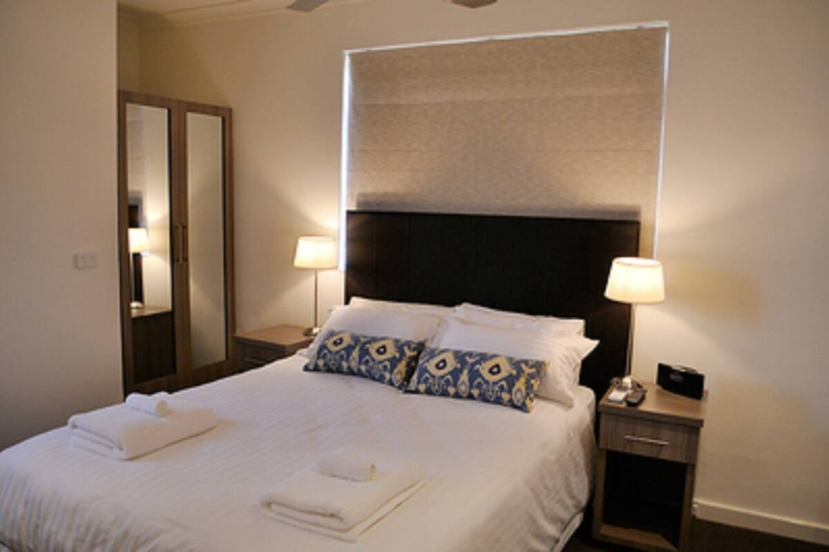 queen ensuite room | premium bedding, desk, laptop workspace, iron/ironing board