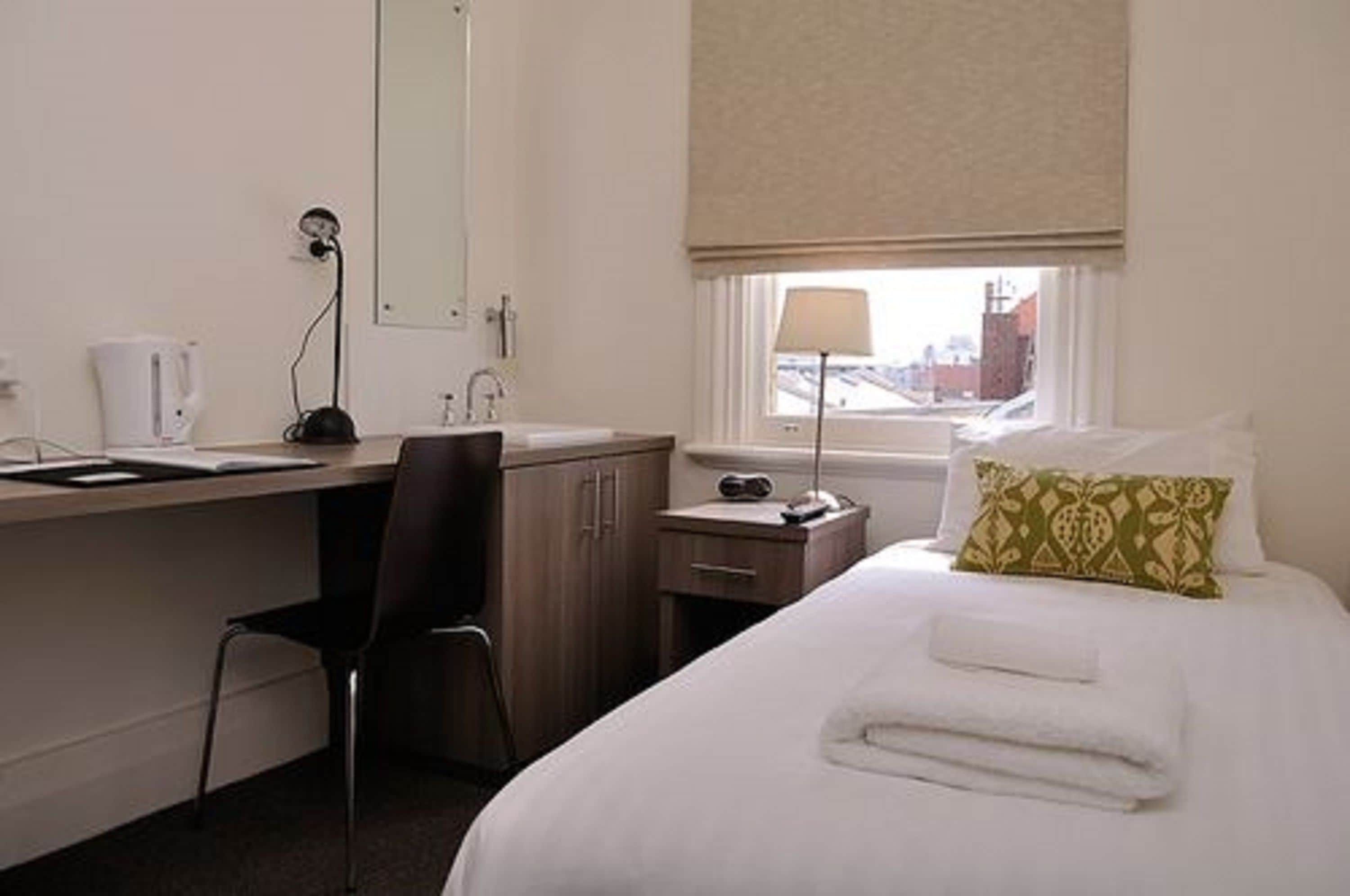 standard single room (shared bathroom) | premium bedding, desk, laptop workspace, iron/ironing board