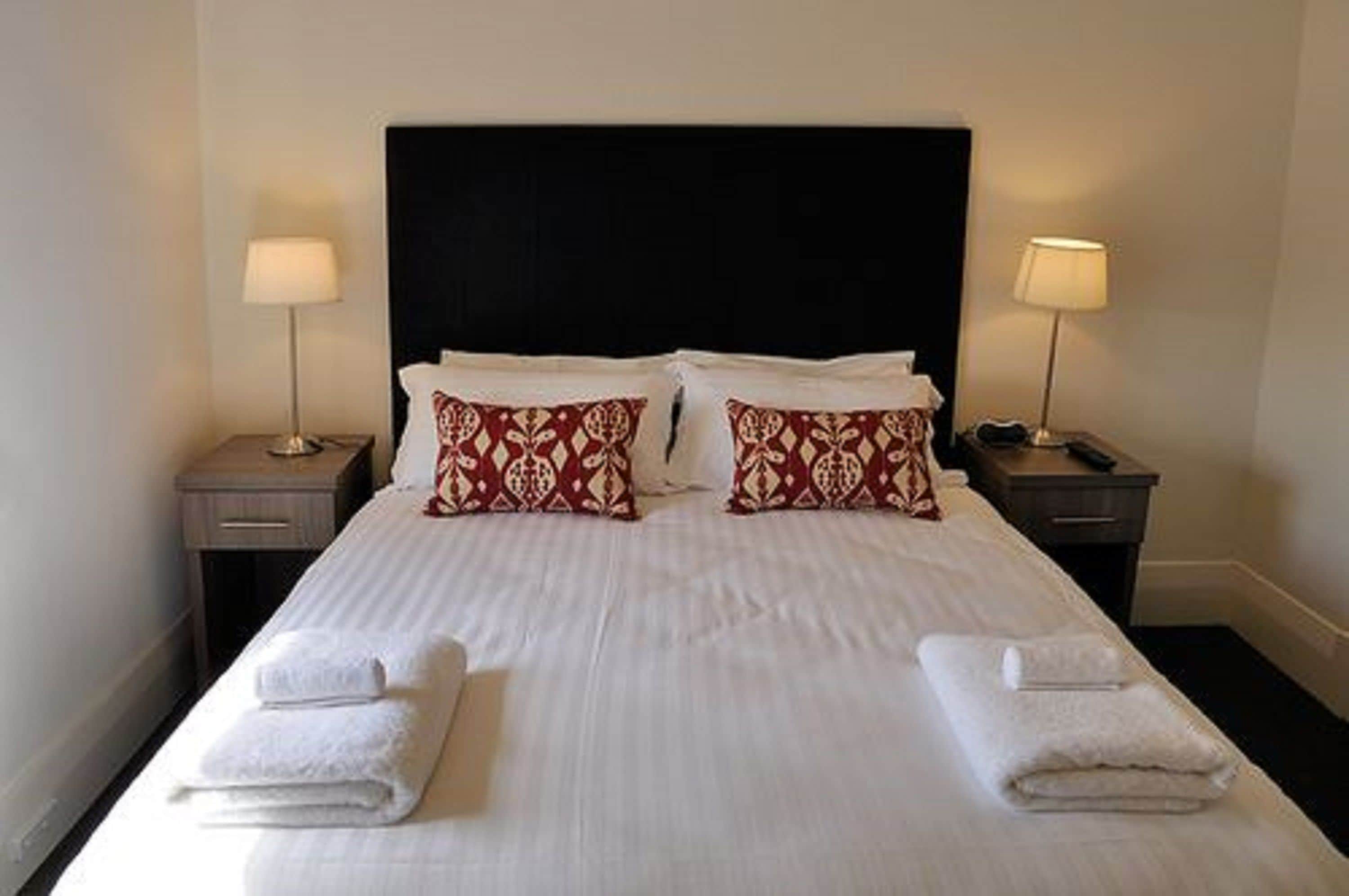 standard queen room (shared bathroom) | premium bedding, desk, laptop workspace, iron/ironing board