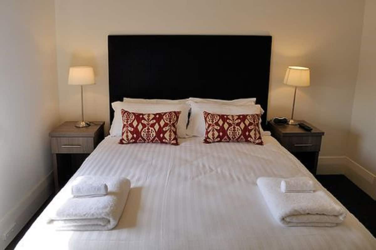 standard queen room (shared bathroom) | premium bedding, desk, laptop workspace, iron/ironing board