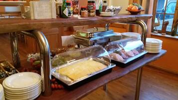 A buffet setup with various food items and condiments.