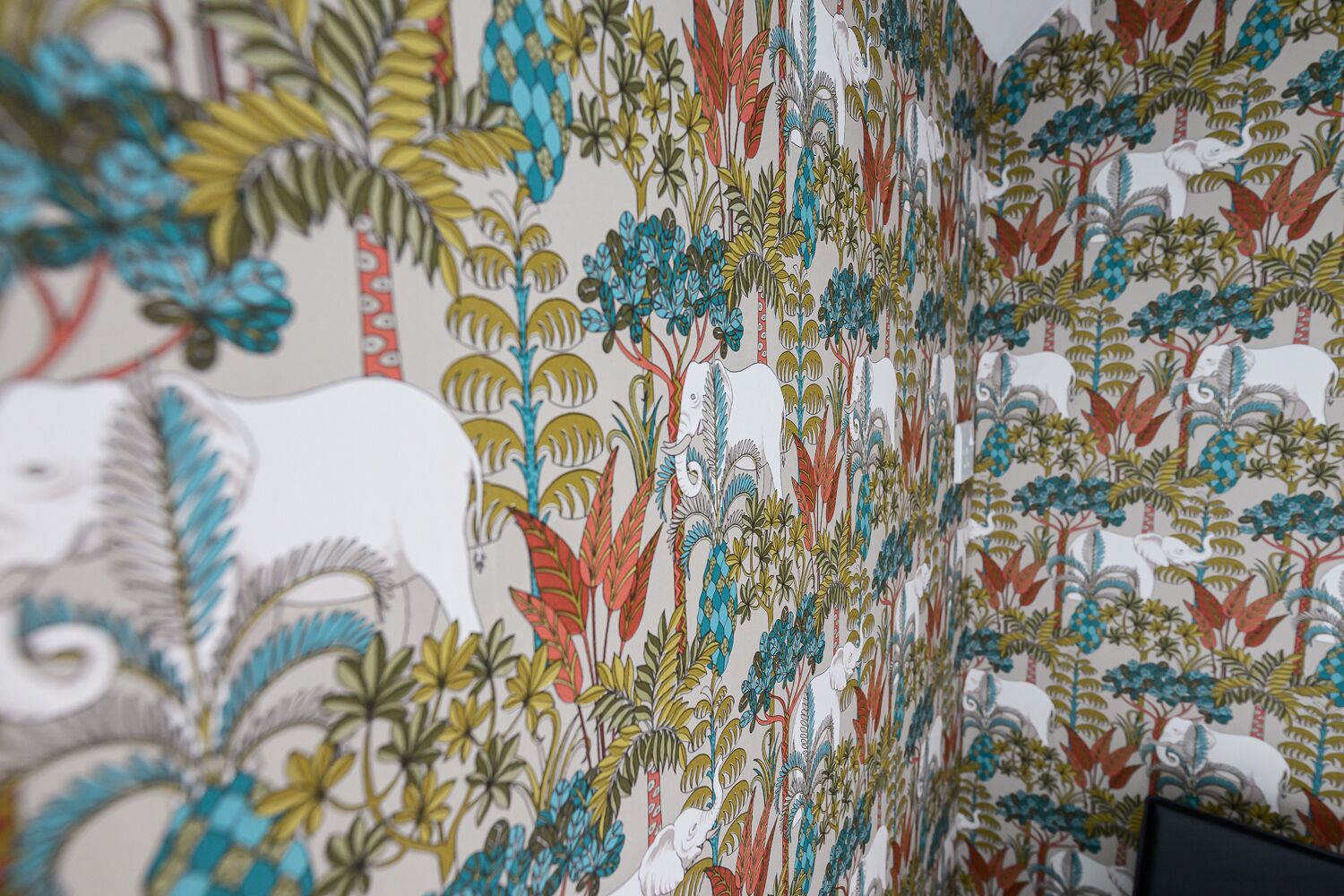 A wall with a detailed, colorful botanical pattern.