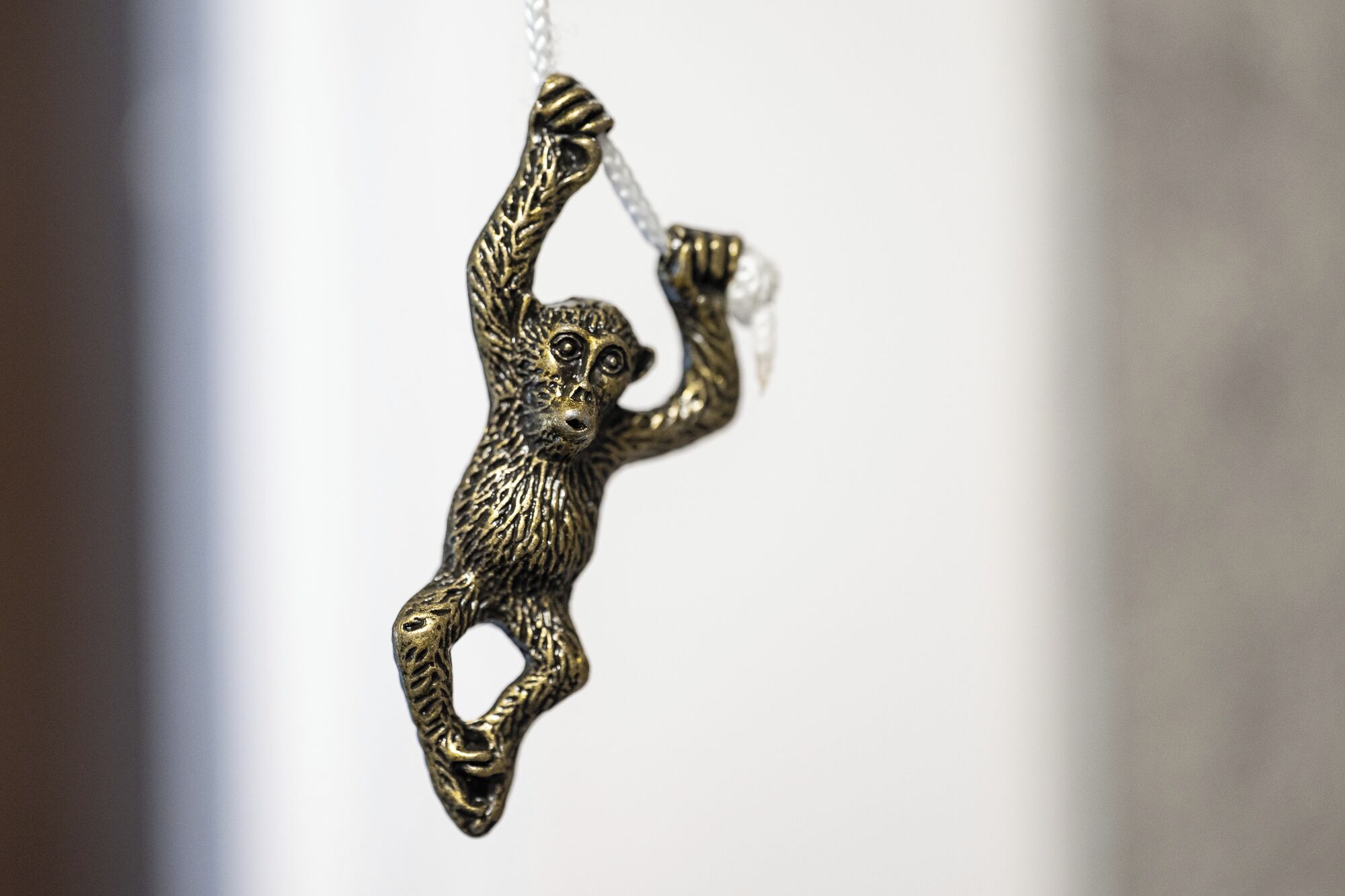A close-up of a hanging ornament shaped like a monkey.