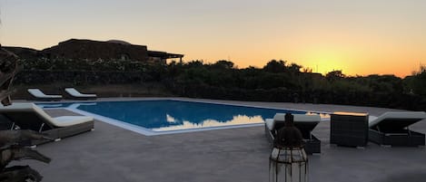 An infinity pool, sun loungers