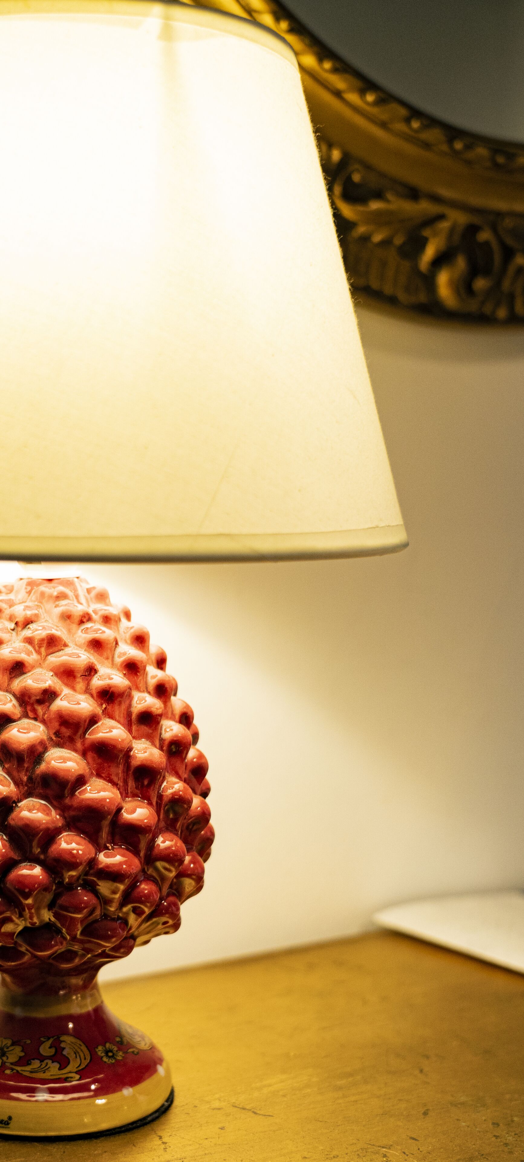 A table lamp with a decorative base and a white lampshade.