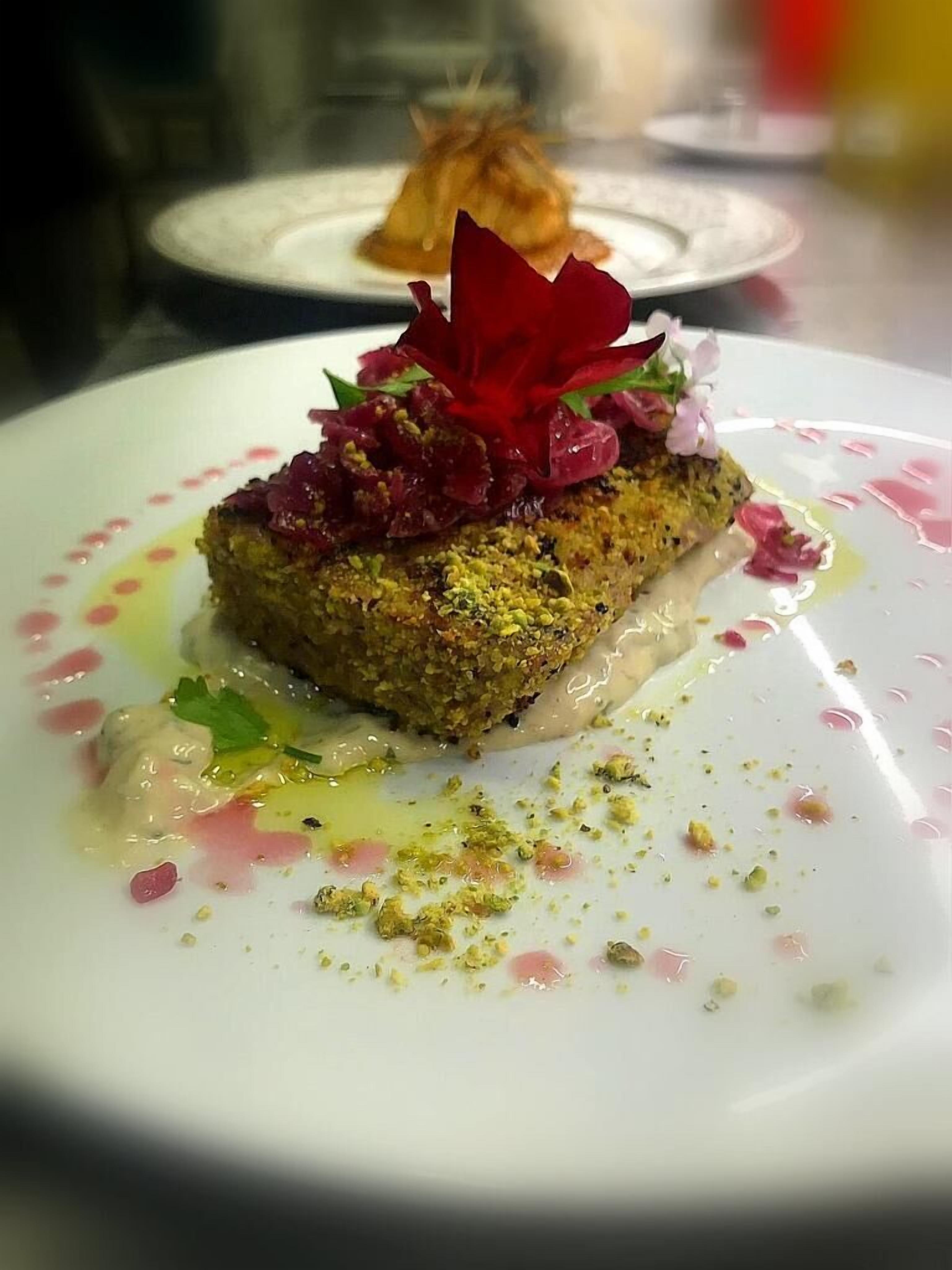 A dessert with a decorative flower on a plate.