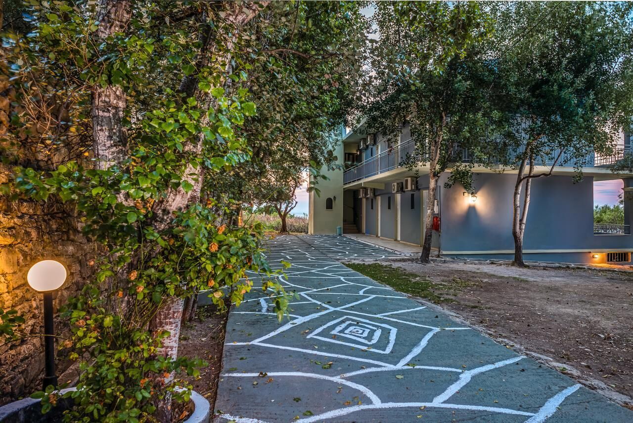 A pathway leading to a building with a geometric pattern on the ground.