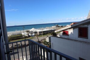 A coastal view from a balcony overlooking a beach and a marina. - Karma Resort (Venetico)