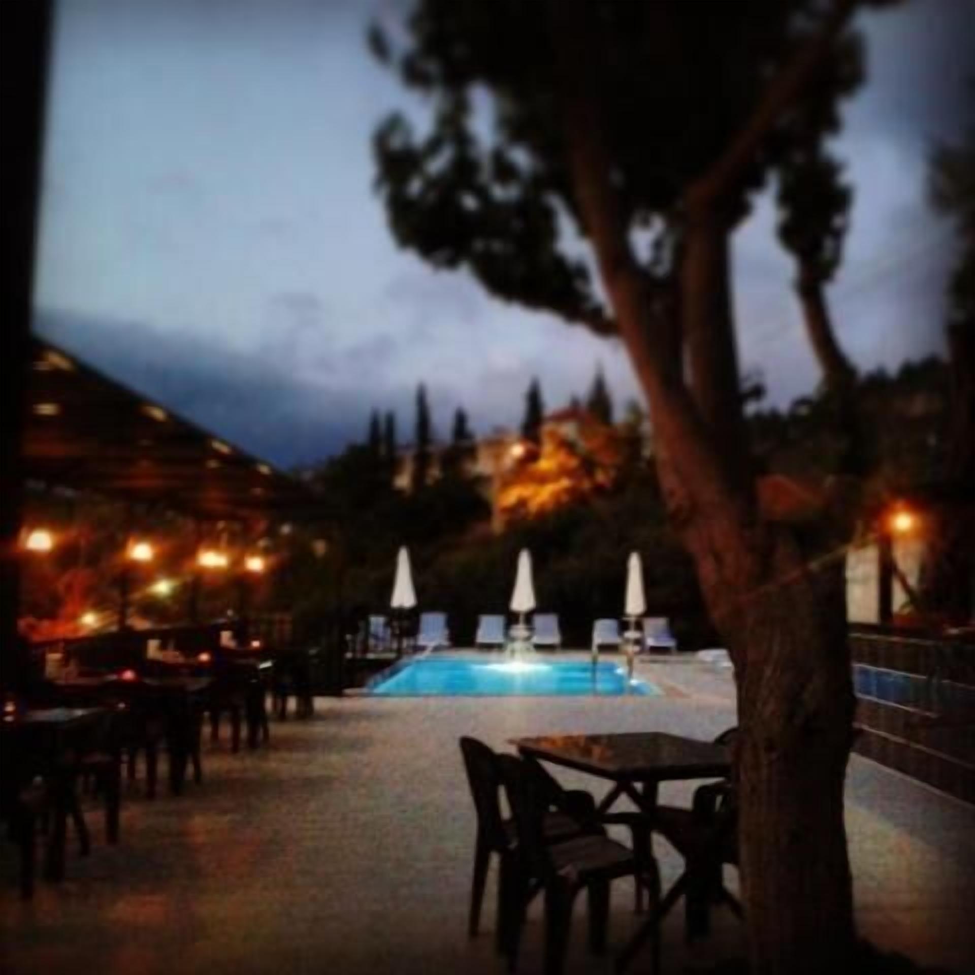 outdoor pool, a waterfall pool, open open 24 hours a day, pool umbrellas