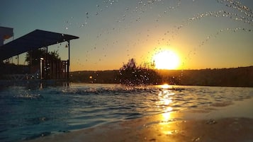 Outdoor pool, a waterfall pool, open open 24 hours a day, pool umbrellas