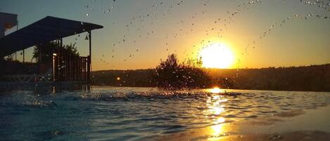 Outdoor pool, a waterfall pool, open open 24 hours, pool umbrellas