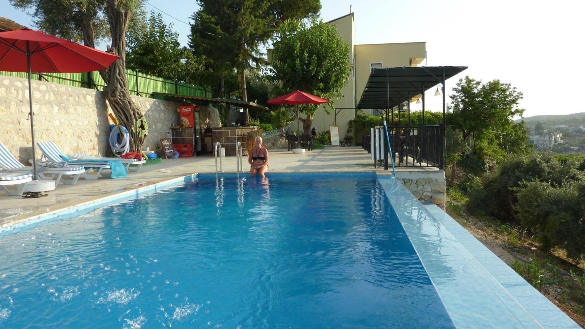 Outdoor pool, a waterfall pool, open open 24 hours, pool umbrellas