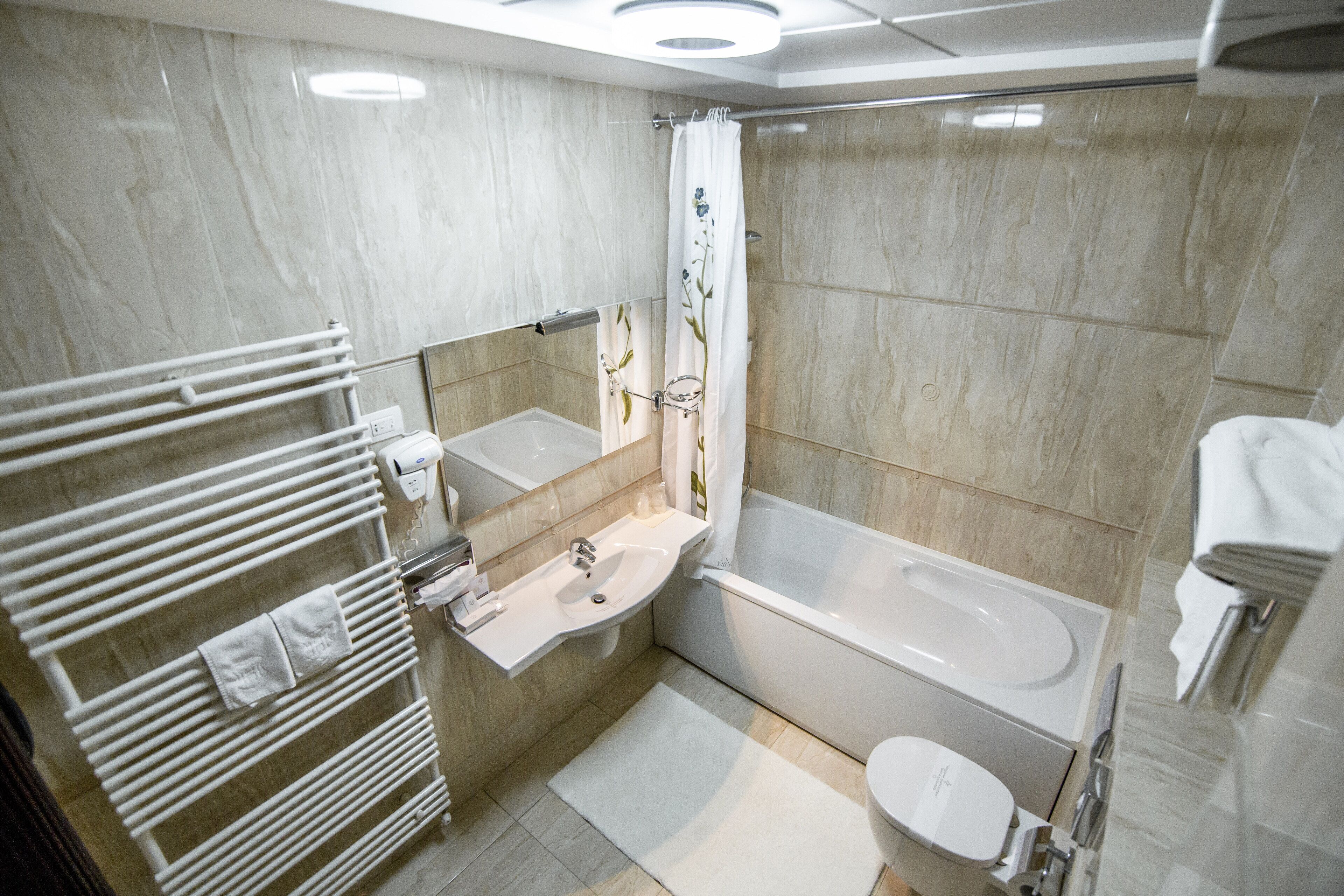 A modern bathroom with a bathtub, a sink, and a toilet.
