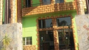 A two-story building with a sign reading "Tassili Lodge". - Tassili Lodge (Kempton Park)