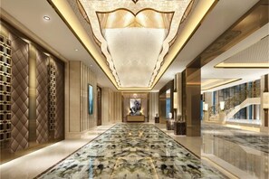 A spacious hallway with a marble floor, a large chandelier, and a staircase on the right. - Zhenye International Hotel (Wuhan)