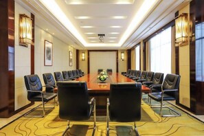 A conference room with a long table, multiple chairs, and a carpeted floor. - Zhenye International Hotel (Wuhan)