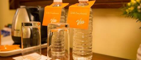 A table with three water bottles labeled "Viva Hotel" and "With Compliments."