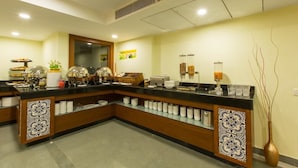 A hotel reception area with a counter, buffet, and various amenities. - Viva Hotel (Margao)