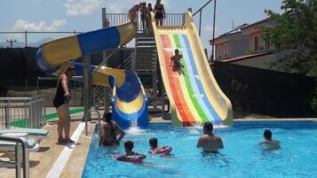 Enjoy a refreshing swim in our pool, featuring two fun water slides and comfortable lounge chairs.