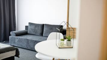 Comfort Quadruple Room, 1 Bedroom | Living area | Flat-screen TV